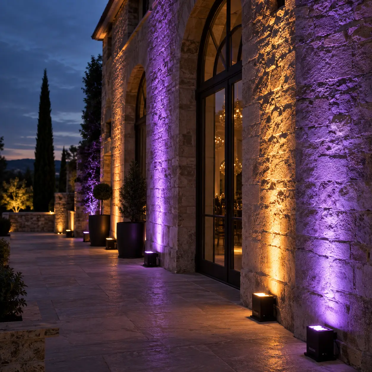 Warm wedding reception lighting over dressed tables